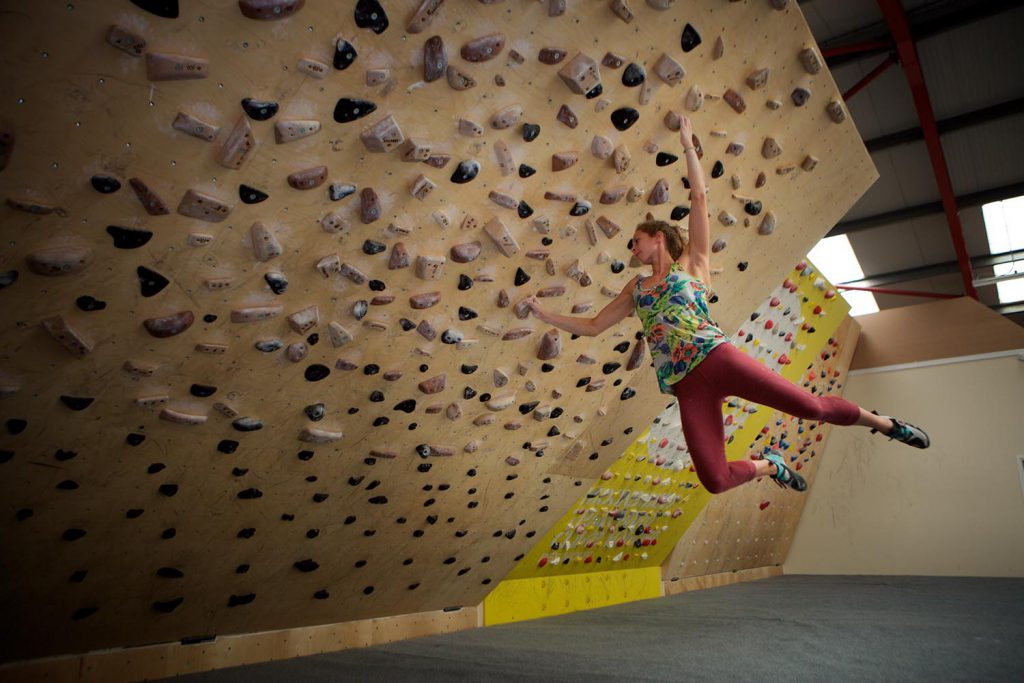 Climber training on a woody board.