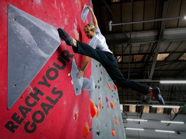 Climber moving easily on the wall with new found flexibility.