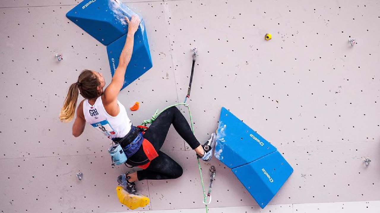 Rhos staying motivated and climbing at an indoor competition