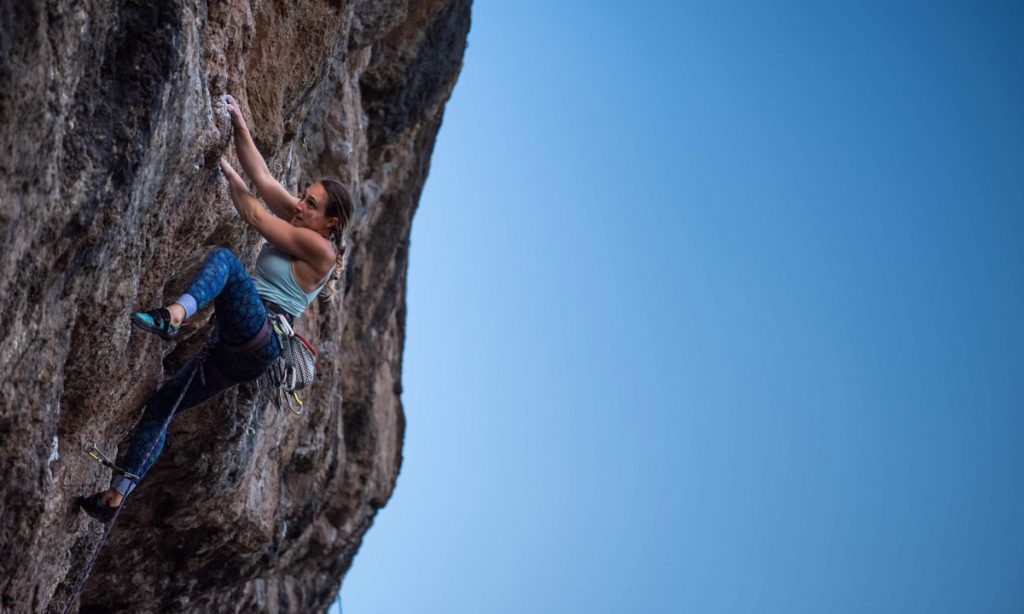 Lattice coach Jemma Powell climbs a sport route outdoors.