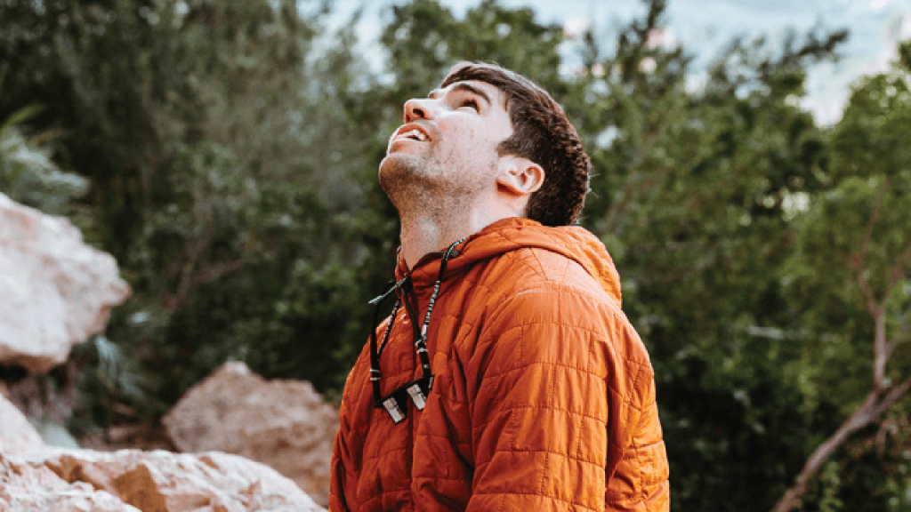 Climber looking up at route feeling overcome by performance anxiety