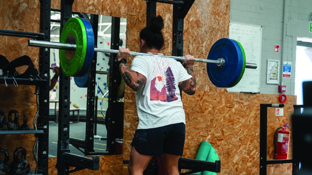 Climber deadlifting to focus on compound movement exercises. 