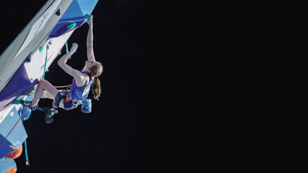 Erin McNiece climbing in a lead competition 
