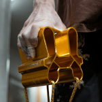 Erin McNeice using the Gold QUad Block in front of a bouldering wall close up