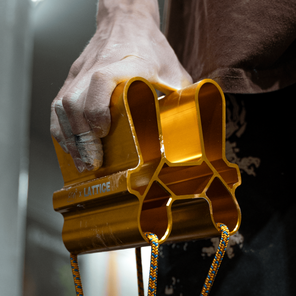 Erin McNeice using the Gold QUad Block in front of a bouldering wall close up