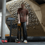 Erin McNeice using the Gold QUad Block in front of a bouldering wall